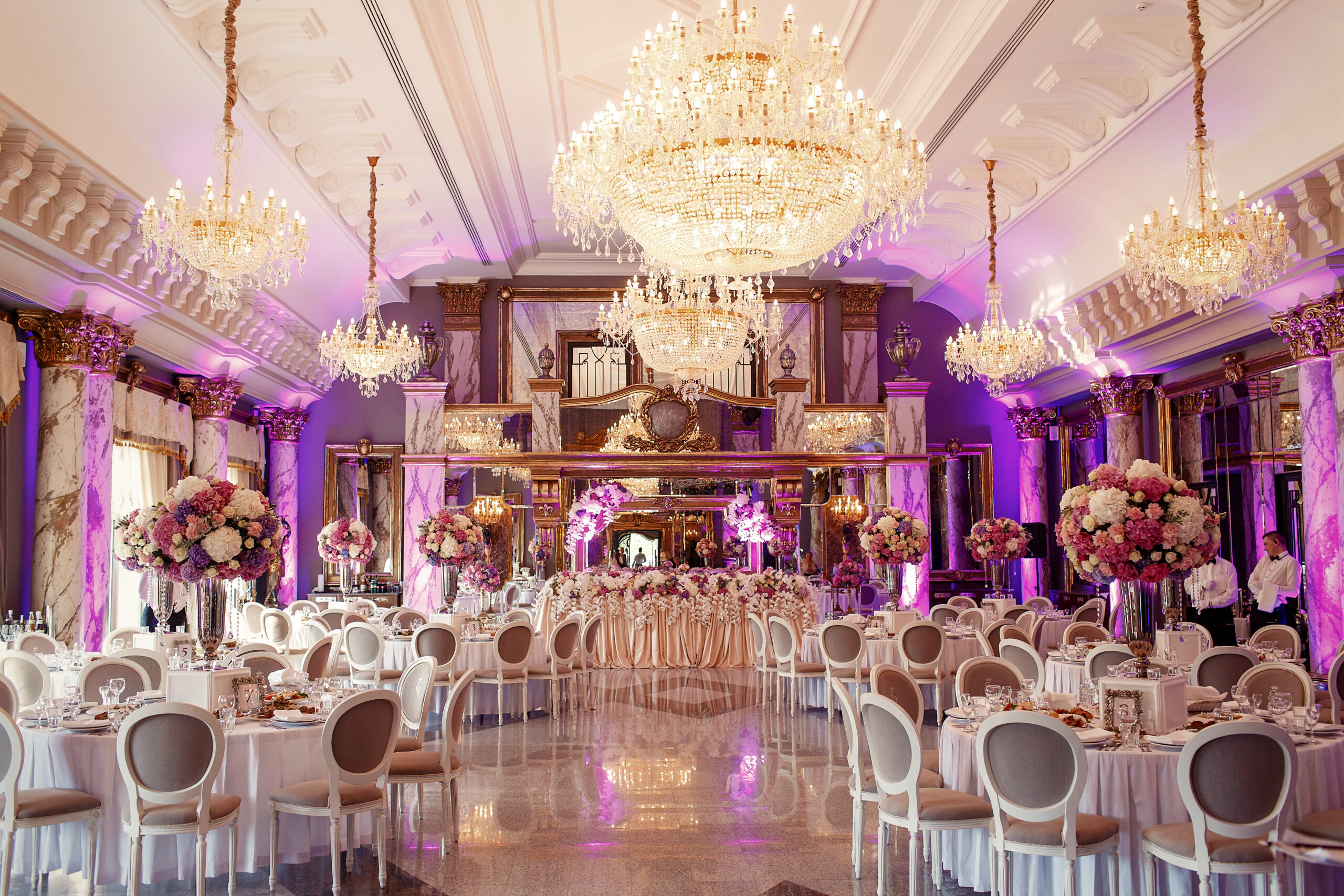luxurious dinner hall with large crystal chandeliers hanging fro
